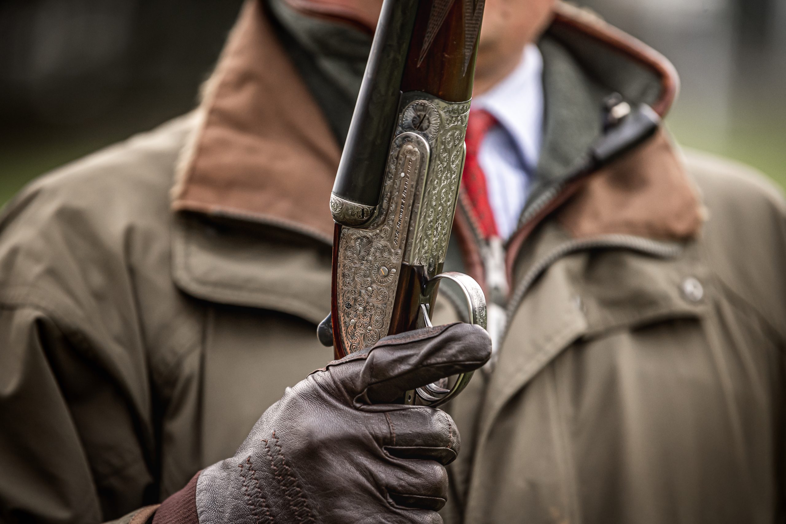 Man holding a side by side shotgun