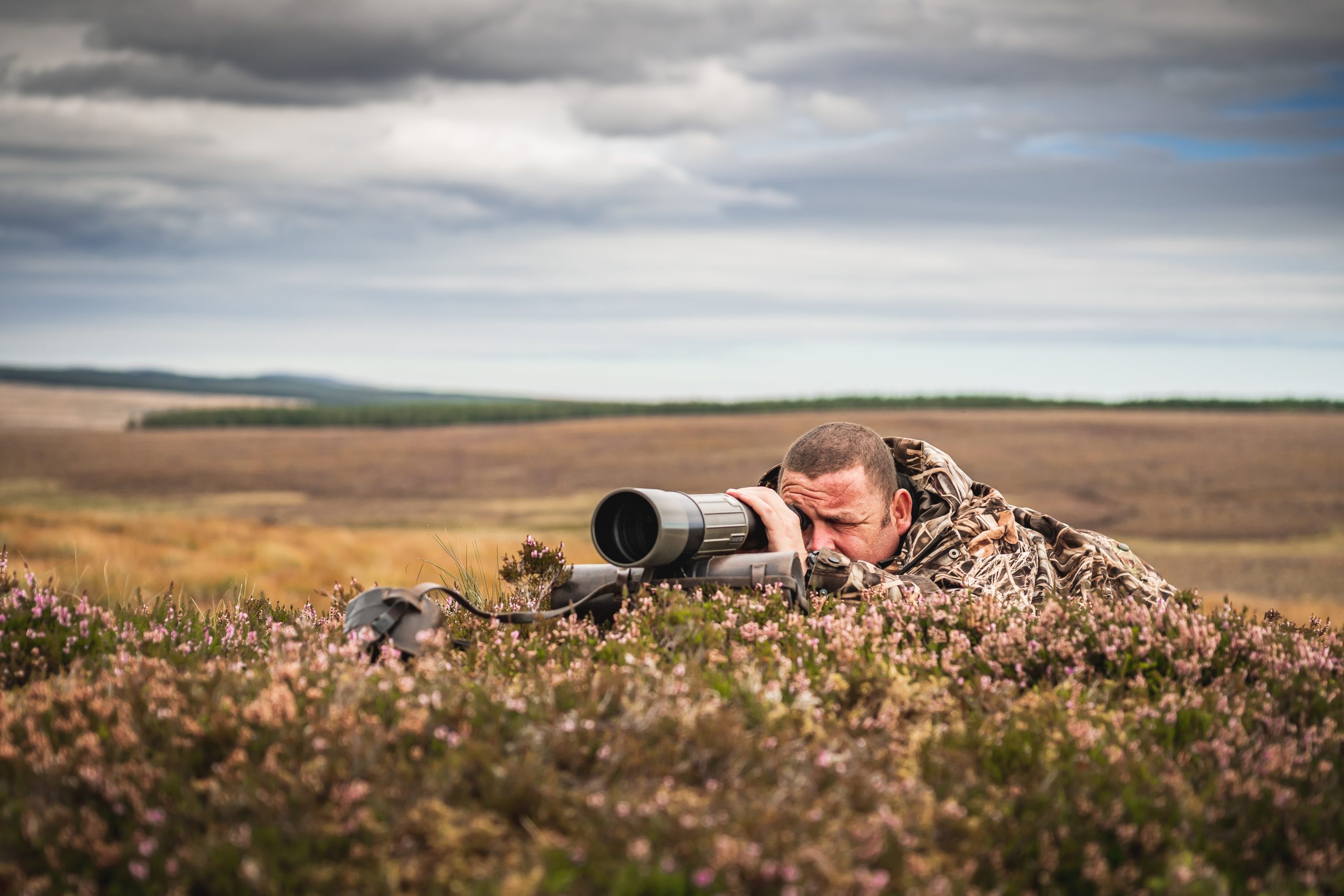 Man looking through a spotting scope