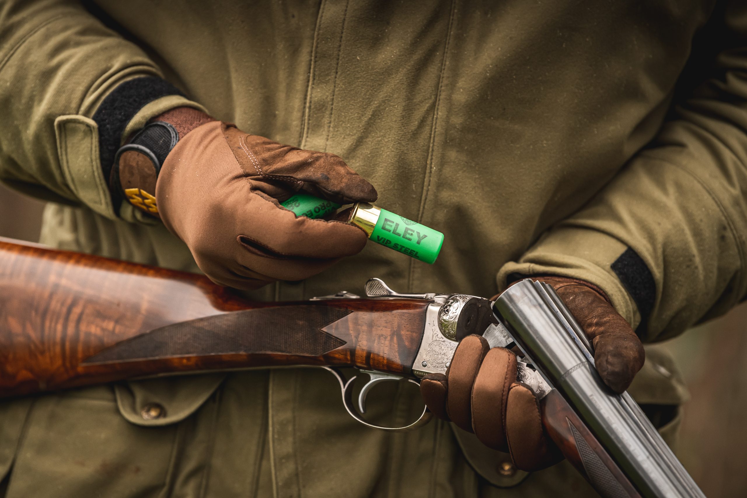 Man loading cartridges into the chamber of his side by side