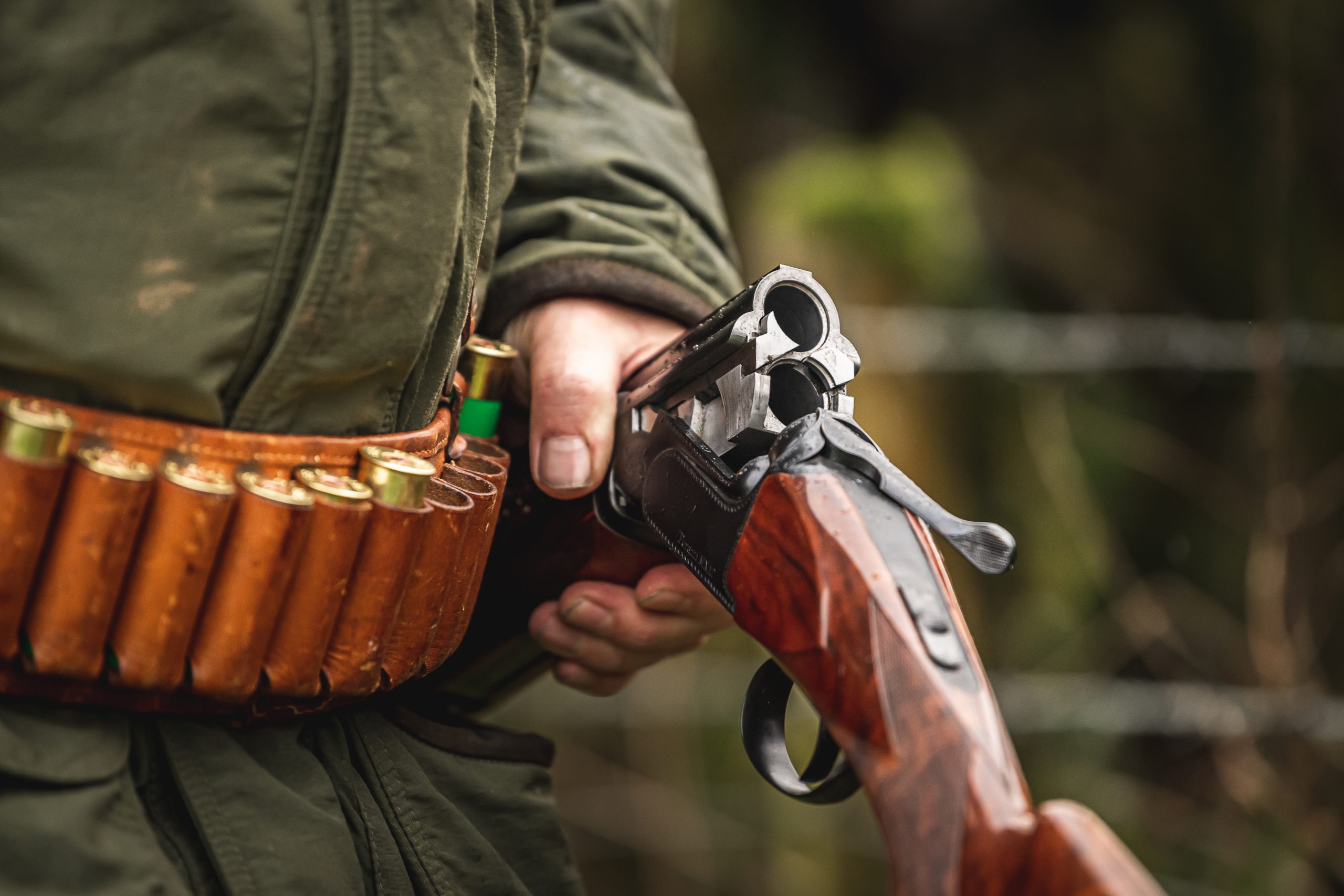 Man carrying an empty over and under shotgun