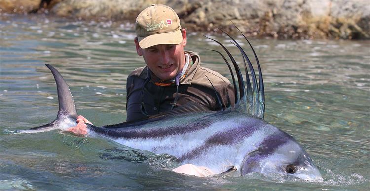 man and roosterfish