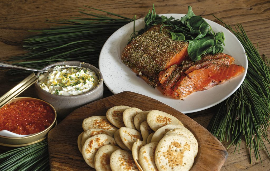 Larch-cured smoked trout with buckwheat blinis and lemon crème fraîche