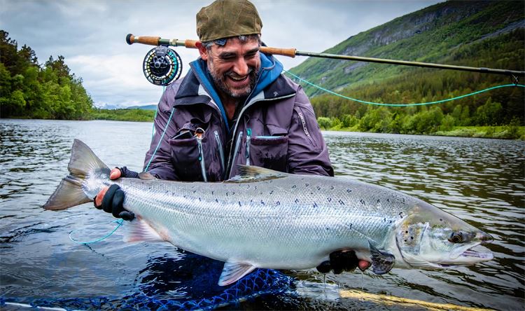 Matt Harris holding fish in Norwegian river