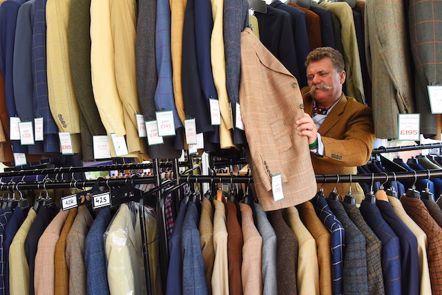 Man searching through coat rack