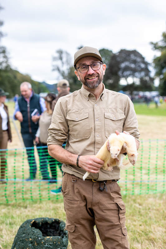 Simon Whitehead standing and holding one of his Pakefield ferrets